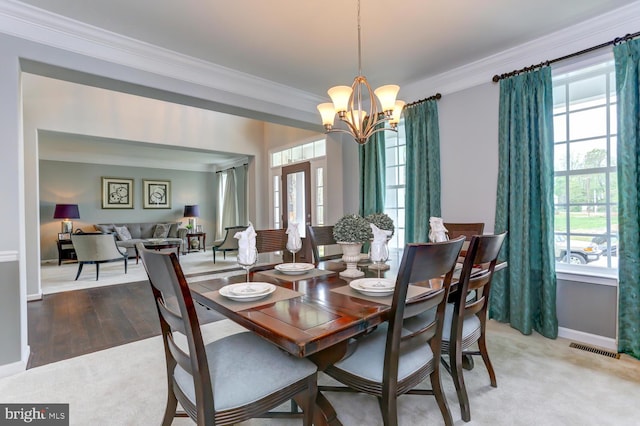 dining area with a notable chandelier, visible vents, and plenty of natural light