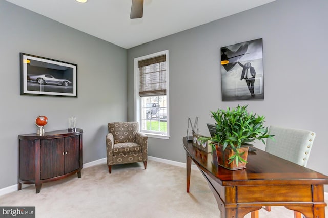 office area featuring a ceiling fan, baseboards, and carpet floors