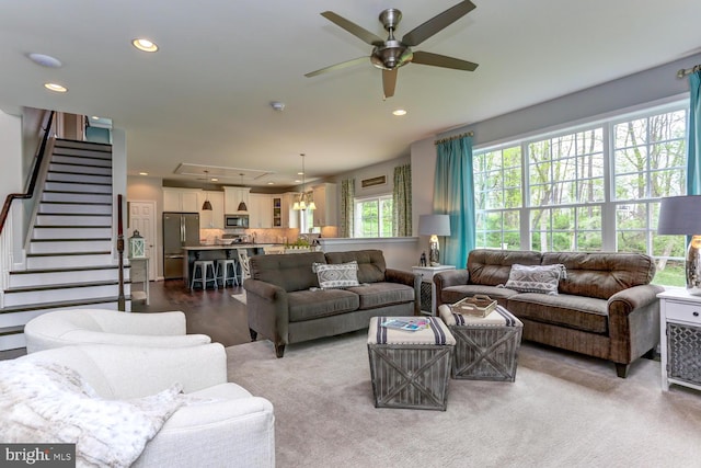 living area with stairway, recessed lighting, and a ceiling fan