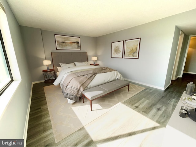 bedroom featuring baseboards and wood finished floors