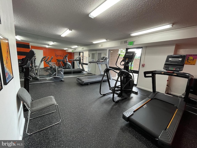 gym with visible vents and a textured ceiling