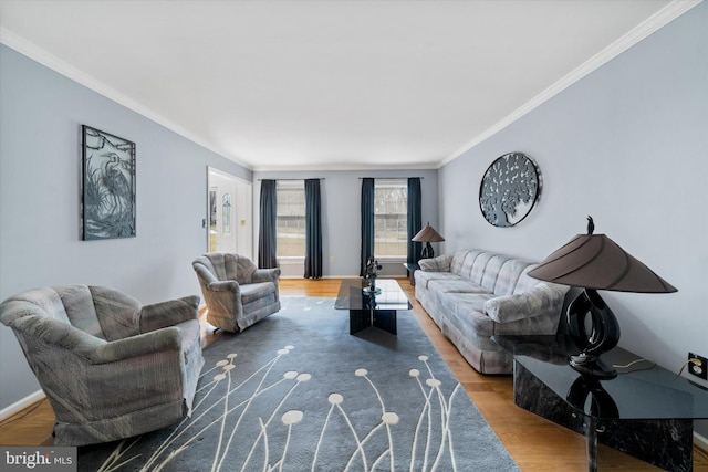 living area with ornamental molding, baseboards, and wood finished floors