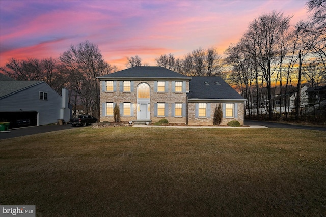 colonial home featuring a lawn