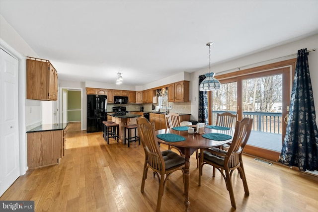 dining room with visible vents and light wood-type flooring