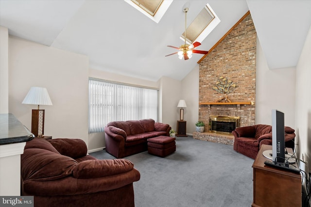 living area featuring high vaulted ceiling, carpet floors, a skylight, a brick fireplace, and ceiling fan