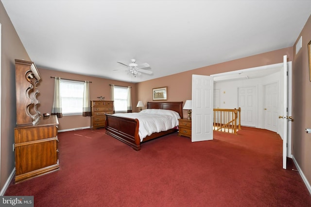 bedroom with dark carpet and baseboards