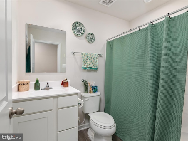 bathroom featuring vanity, wood finished floors, visible vents, curtained shower, and toilet