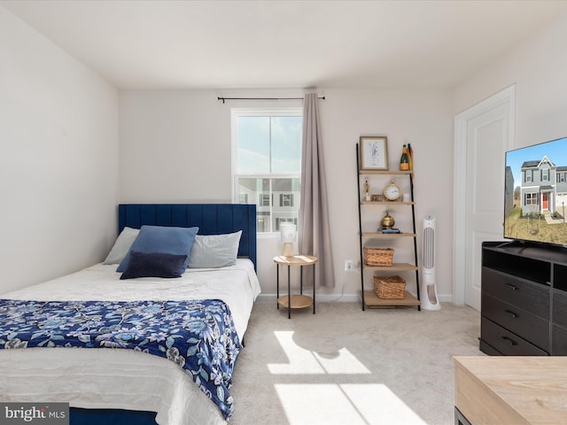 bedroom with baseboards and carpet floors