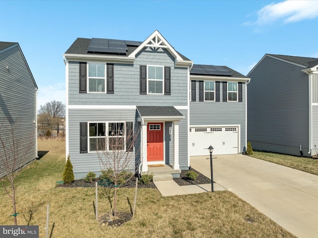 view of front of property with a front lawn, driveway, roof mounted solar panels, a shingled roof, and a garage