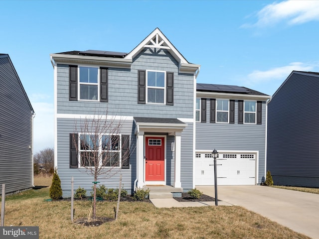 view of front facade featuring roof mounted solar panels, driveway, an attached garage, and a front lawn