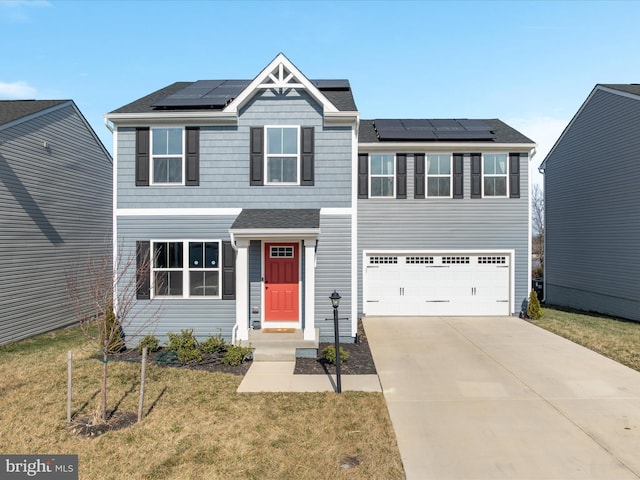 view of front of house with a front yard, roof with shingles, solar panels, an attached garage, and concrete driveway