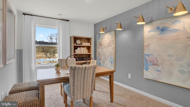 dining room featuring baseboards and carpet floors