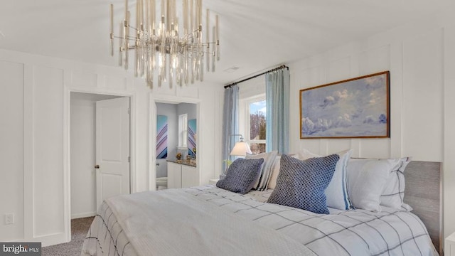 carpeted bedroom with an inviting chandelier and a decorative wall