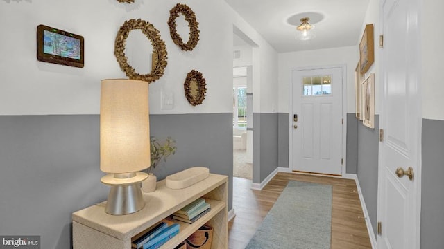 entryway featuring visible vents, light wood-style flooring, and baseboards