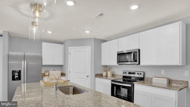 kitchen with visible vents, white cabinets, appliances with stainless steel finishes, and a sink