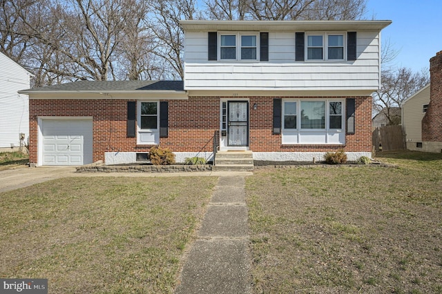 colonial house with brick siding, an attached garage, concrete driveway, and a front yard