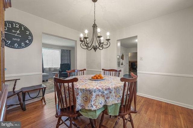 dining room featuring baseboards and hardwood / wood-style flooring