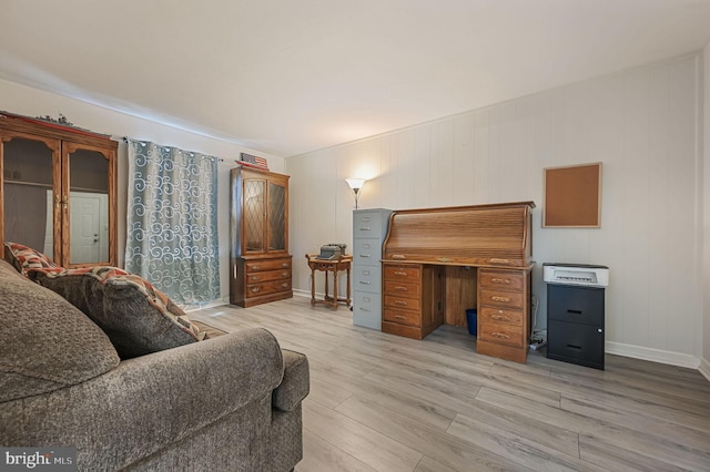 living area with light wood finished floors and baseboards