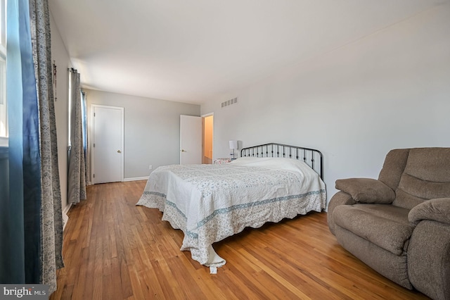 bedroom with visible vents and light wood-type flooring