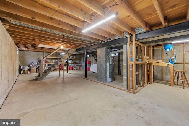 unfinished basement featuring stairway