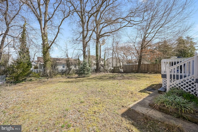 view of yard with a deck and fence