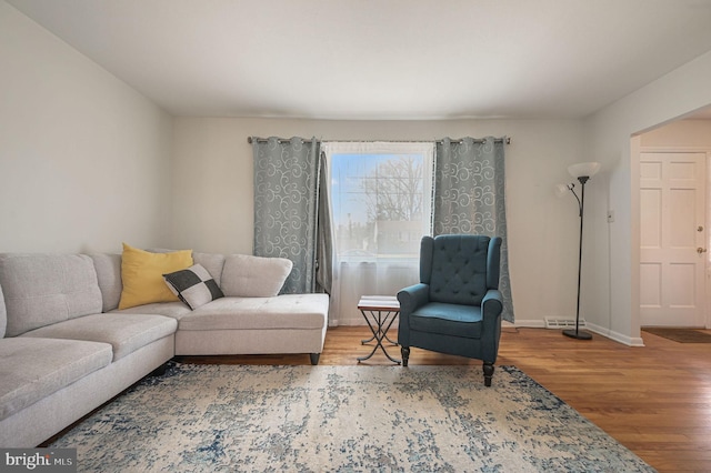 living area featuring wood finished floors and baseboards