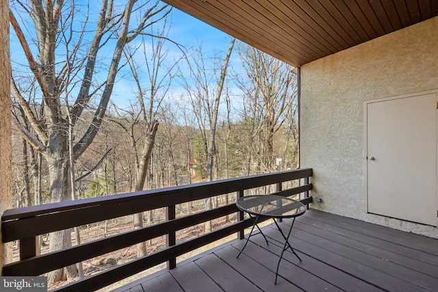 wooden terrace with a view of trees