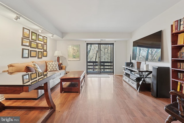 living area featuring track lighting and wood finished floors