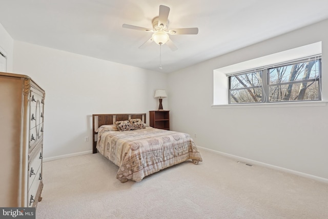 carpeted bedroom featuring visible vents, baseboards, and a ceiling fan