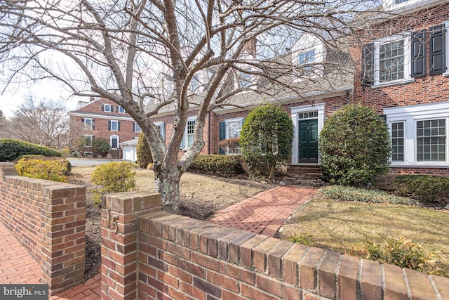 view of front of home featuring brick siding and entry steps