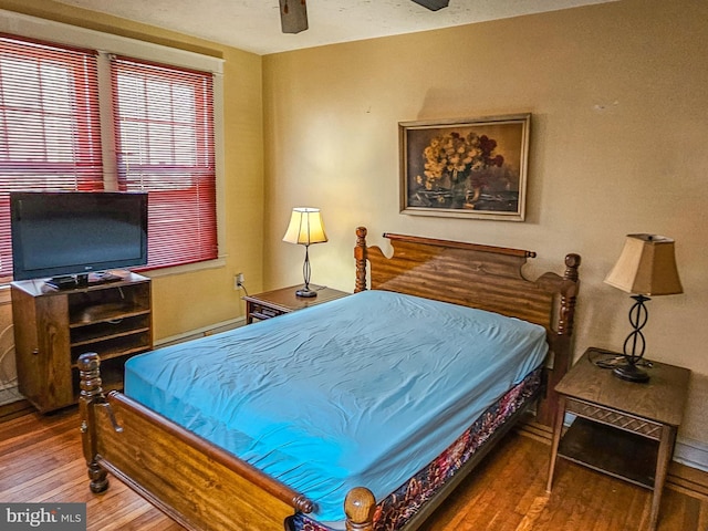 bedroom with ceiling fan and wood finished floors