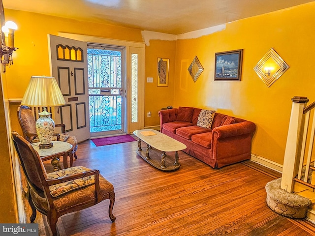 living room with baseboards and wood finished floors