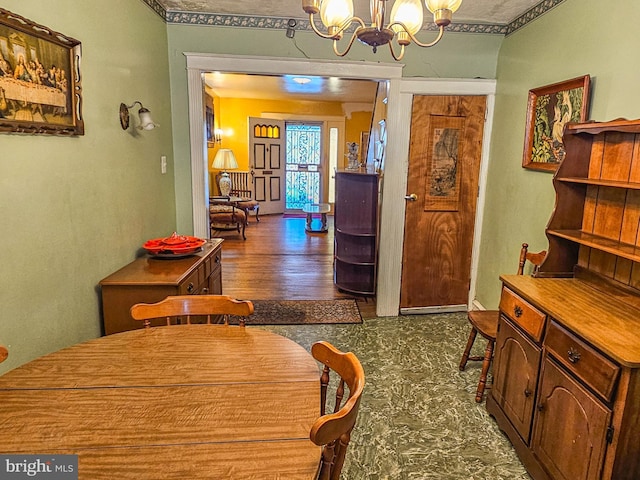 dining room featuring an inviting chandelier and dark wood finished floors