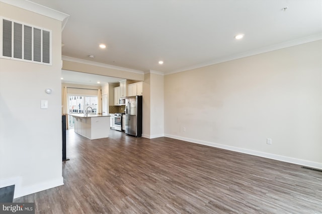 unfurnished living room with visible vents, baseboards, dark wood-style floors, and crown molding