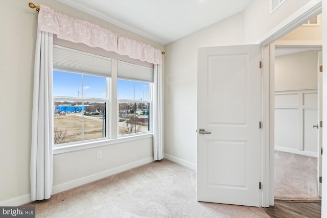 interior space with vaulted ceiling, carpet, visible vents, and baseboards