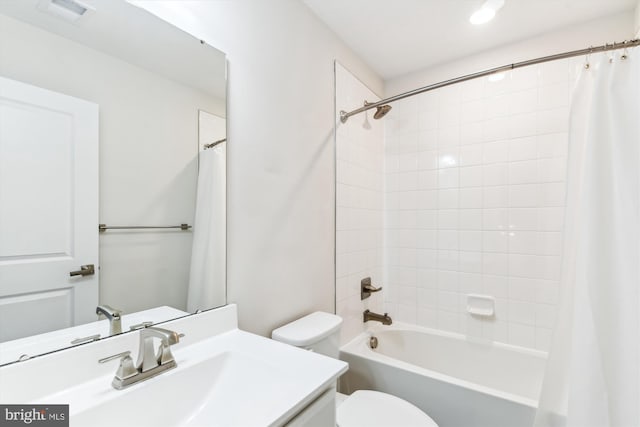 bathroom with visible vents, toilet, shower / bath combo, and vanity