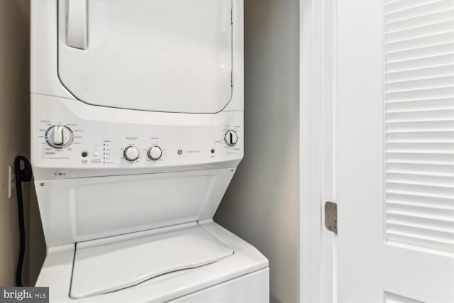 washroom featuring laundry area and stacked washer / drying machine