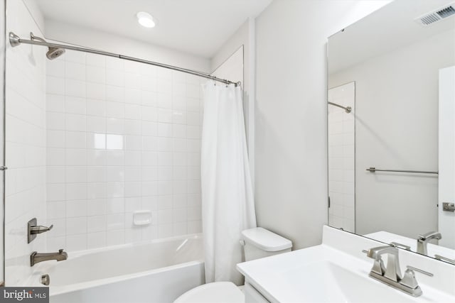 bathroom featuring visible vents, toilet, shower / bath combo, and vanity