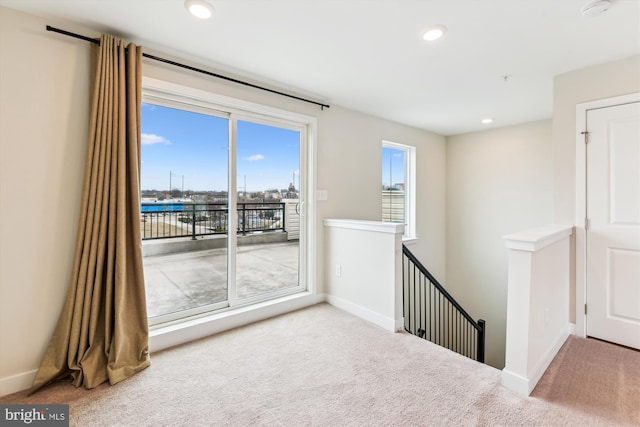 carpeted empty room featuring recessed lighting and baseboards