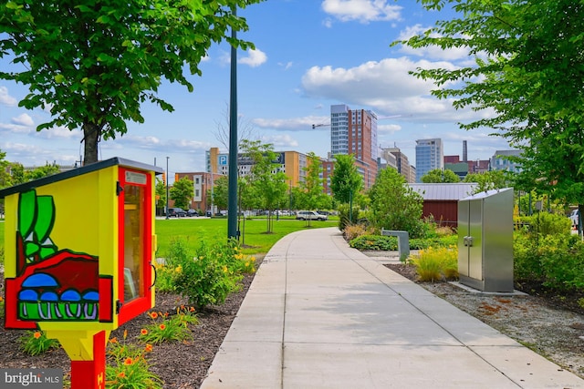 view of home's community featuring a city view and a lawn