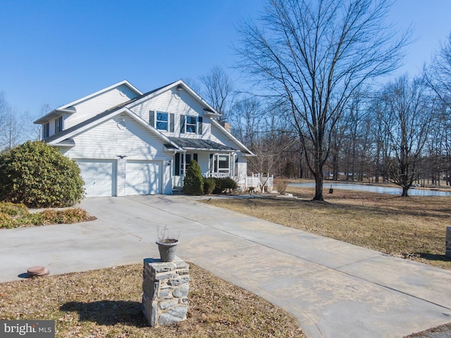 view of front facade with a porch, a garage, and driveway