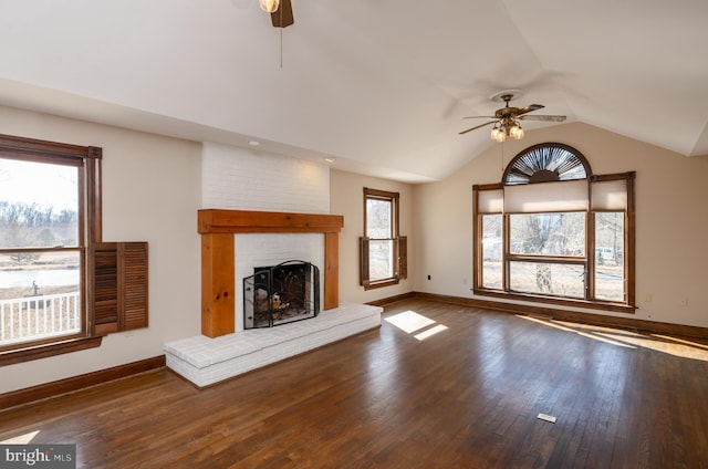 unfurnished living room featuring hardwood / wood-style flooring, a ceiling fan, and a wealth of natural light