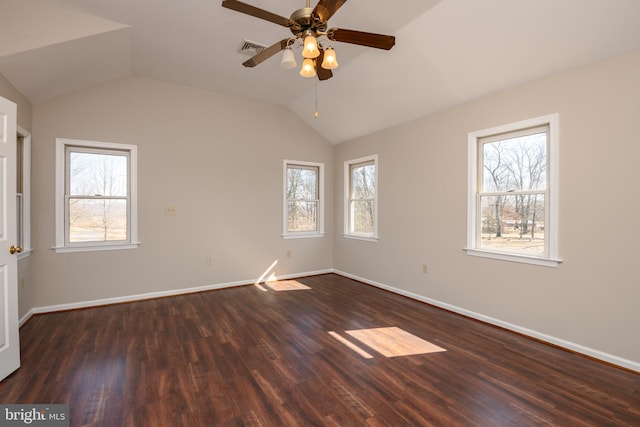 unfurnished room featuring visible vents, a ceiling fan, dark wood-style floors, baseboards, and lofted ceiling