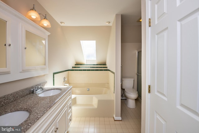 full bathroom featuring tile patterned flooring, toilet, a garden tub, a skylight, and a sink