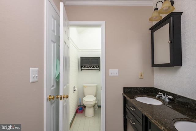 bathroom with tile patterned floors, crown molding, and a sink