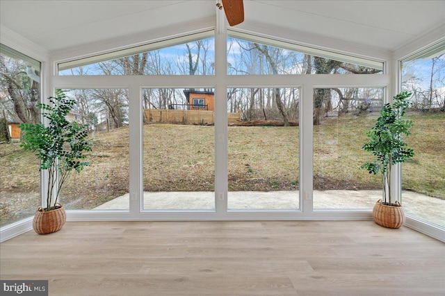 unfurnished sunroom featuring vaulted ceiling with beams