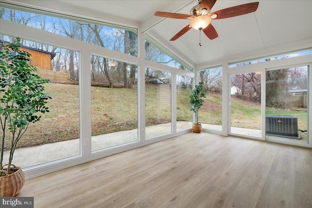 unfurnished sunroom featuring vaulted ceiling with beams, a wealth of natural light, and ceiling fan