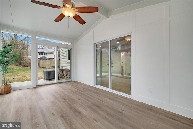 unfurnished sunroom featuring vaulted ceiling and a ceiling fan