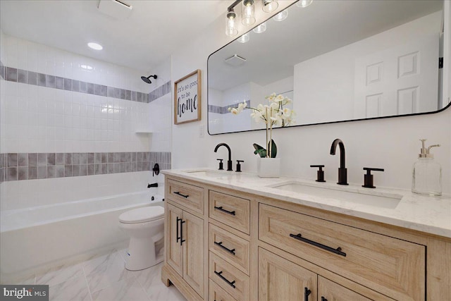 full bath featuring double vanity, toilet, marble finish floor, and a sink