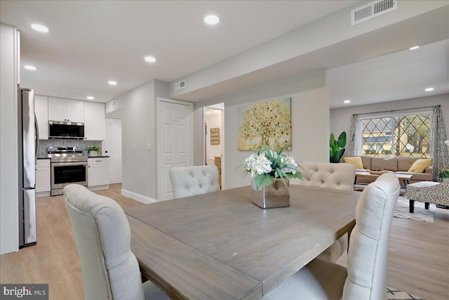 dining space featuring visible vents, recessed lighting, and light wood-type flooring